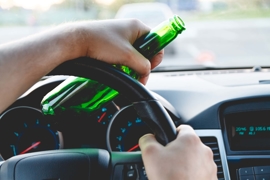 Driving with a beer bottle in hand 